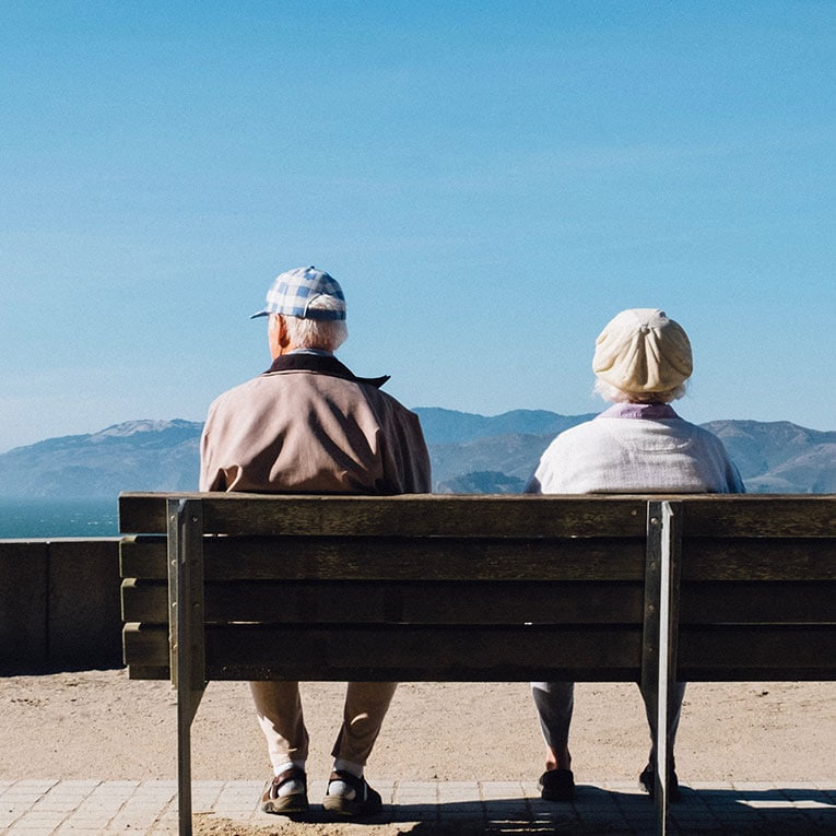 Elderly couple sitting on bench